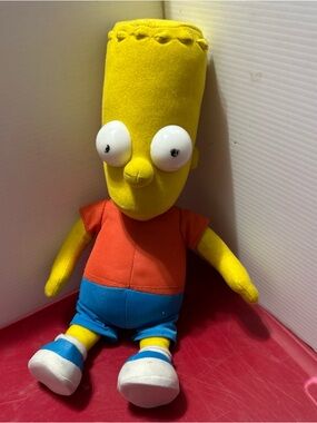 Yellow Plush Cartoon Character Doll with Orange Shirt and Blue Shorts